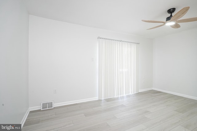 unfurnished room with light wood-type flooring, visible vents, ceiling fan, and baseboards