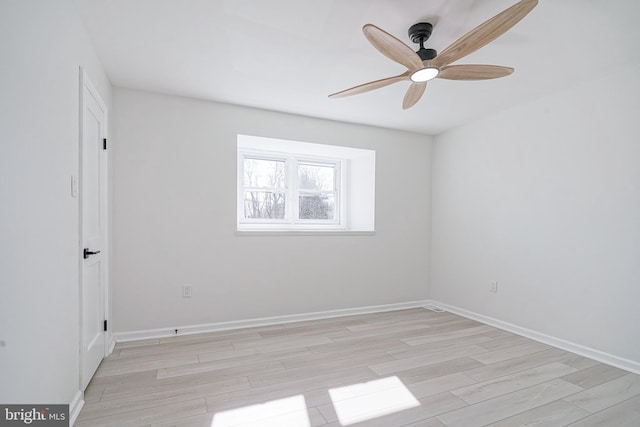 unfurnished room featuring light wood-type flooring, ceiling fan, and baseboards