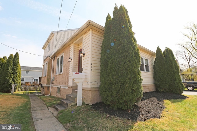 view of home's exterior with a lawn