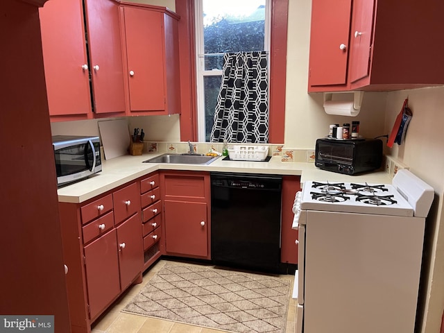 kitchen with black dishwasher, white gas range oven, red cabinets, stainless steel microwave, and a sink