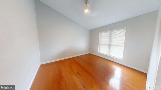 130 Saint Charles Sq Unit 130, Sterling, VA 20164 - spare room with wood finished floors, lofted ceiling, and baseboards