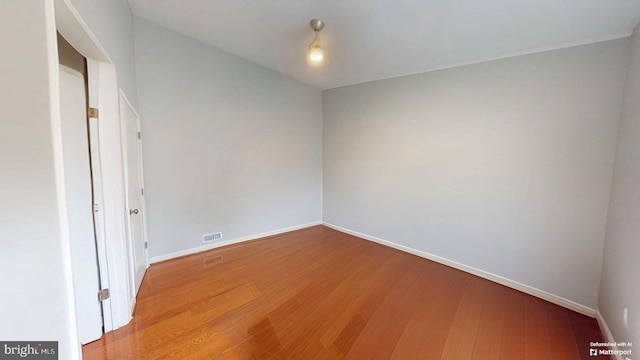 130 Saint Charles Sq Unit 130, Sterling, VA 20164 - unfurnished room featuring wood finished floors, visible vents, and baseboards