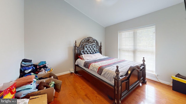130 Saint Charles Sq Unit 130, Sterling, VA 20164 - bedroom with light wood-type flooring, vaulted ceiling, and baseboards