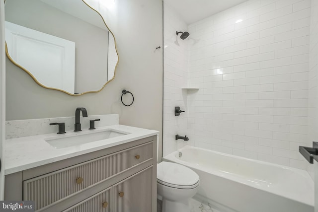 bathroom featuring marble finish floor, vanity, toilet, and bathing tub / shower combination