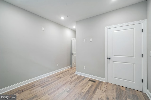 interior space with light wood-style flooring, recessed lighting, visible vents, and baseboards