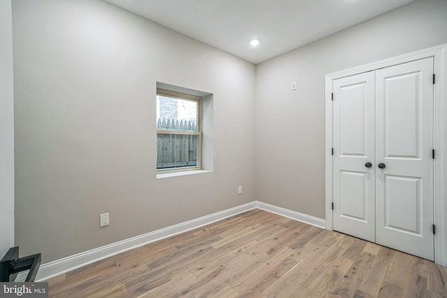 bedroom featuring recessed lighting, a closet, baseboards, and light wood finished floors