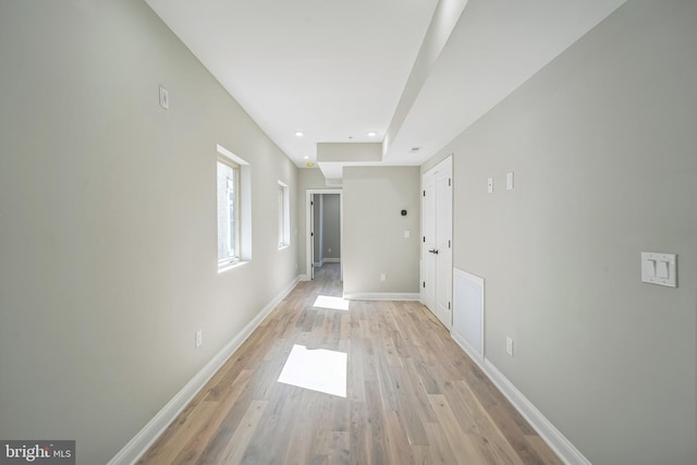 spare room featuring light wood-style floors, baseboards, and recessed lighting