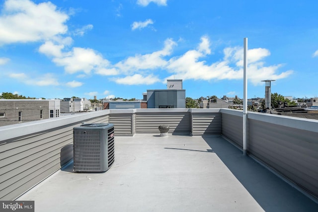 view of patio with a balcony and central AC unit