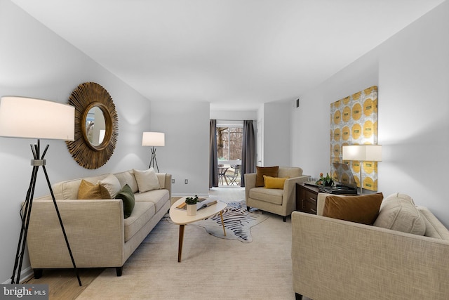 living room featuring light wood-style flooring and baseboards