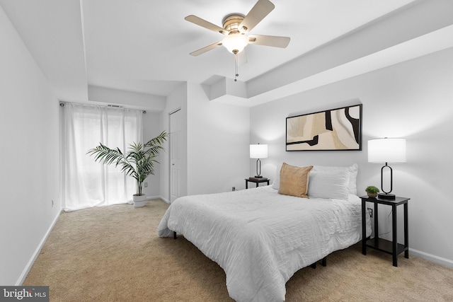 bedroom with ceiling fan, carpet flooring, and baseboards