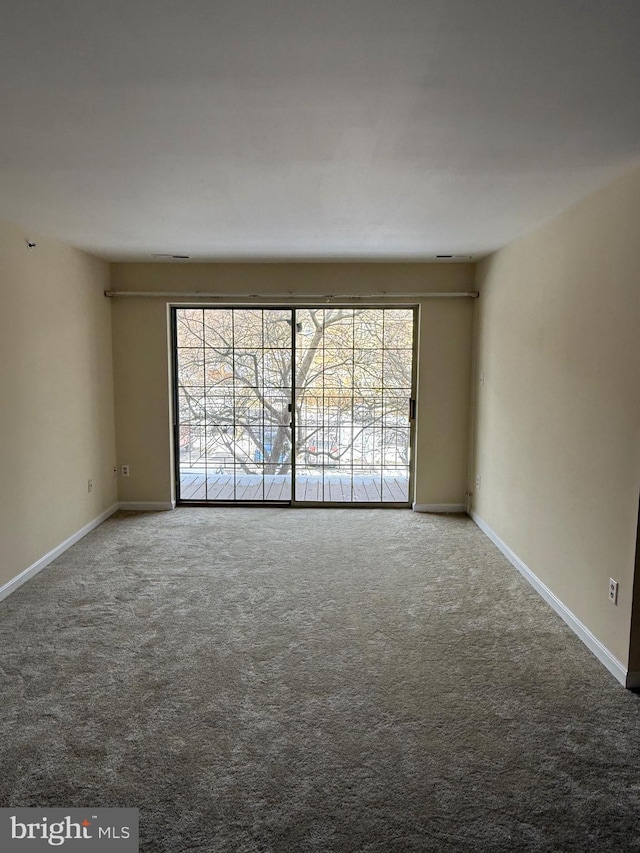 empty room with carpet flooring and baseboards