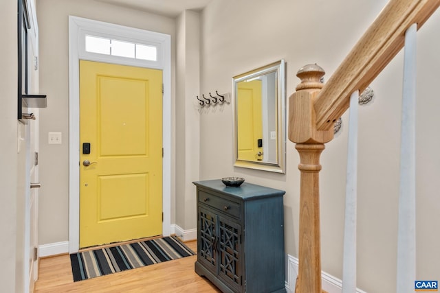 entrance foyer with baseboards and wood finished floors