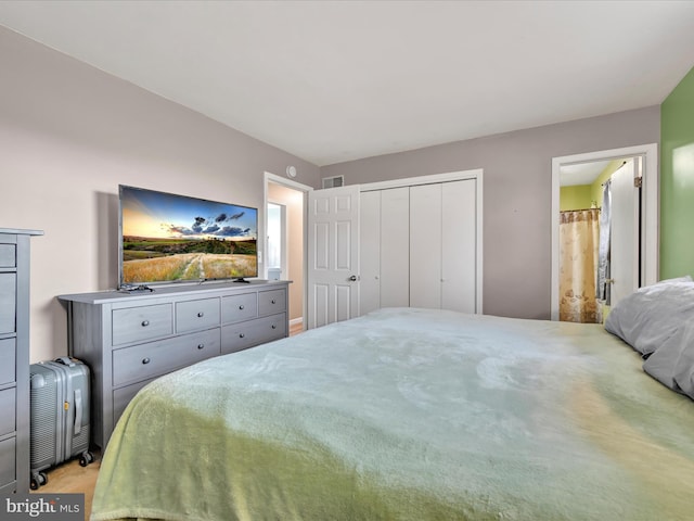 bedroom with visible vents, a closet, and ensuite bathroom