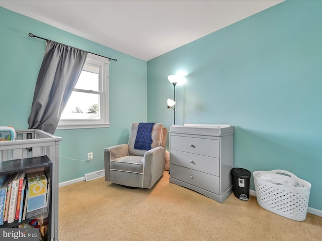 living area with visible vents, baseboards, and carpet floors