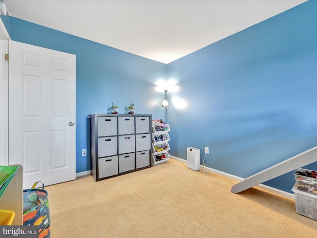 rec room featuring baseboards and carpet