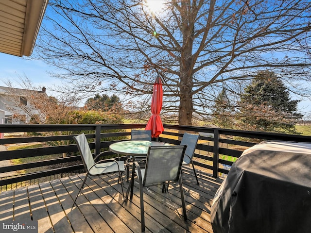 deck featuring grilling area and outdoor dining area