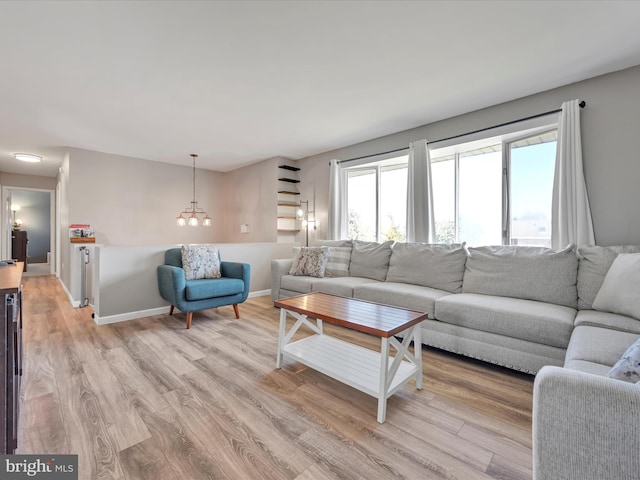 living room with baseboards and light wood finished floors