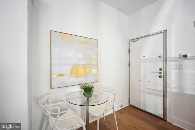 dining room featuring wood finished floors and baseboards