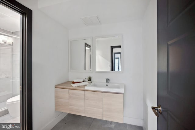 bathroom with toilet, tile patterned flooring, vanity, and baseboards