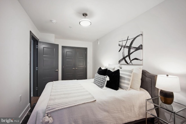 bedroom with a closet and baseboards