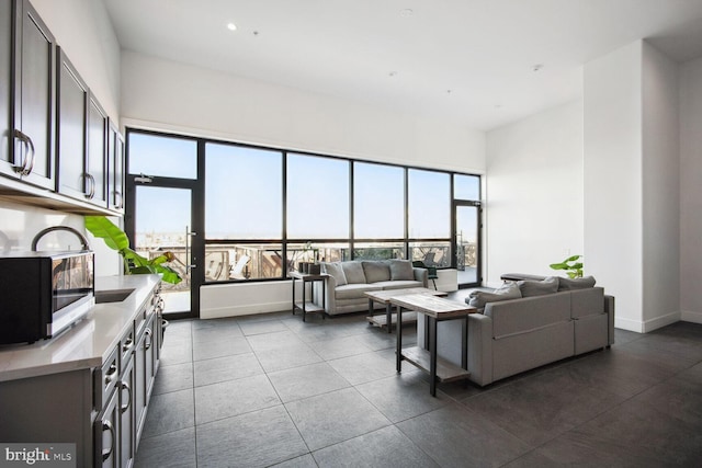 living room with recessed lighting, plenty of natural light, and baseboards