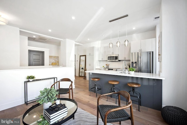 interior space with recessed lighting, visible vents, and wood finished floors