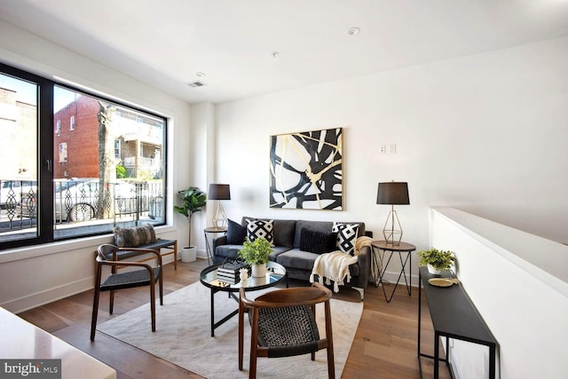 living area featuring baseboards and wood finished floors