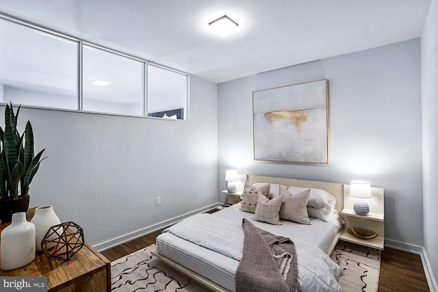 bedroom featuring dark wood-type flooring and baseboards