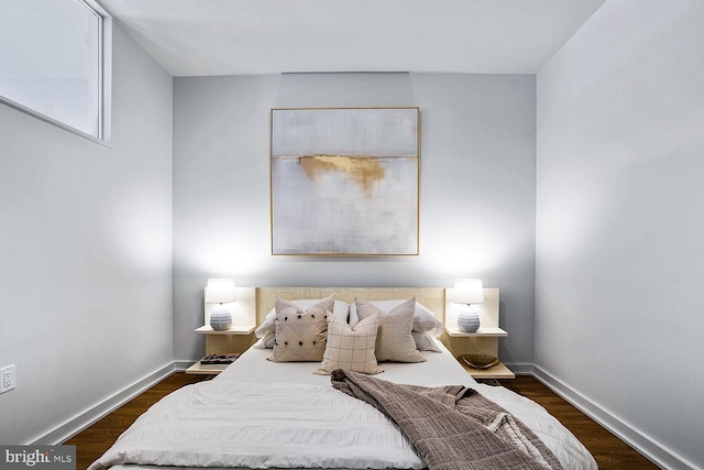 bedroom featuring dark wood-style flooring and baseboards