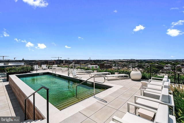 community pool featuring a patio area and fence