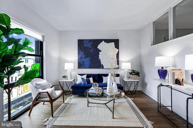 living room featuring dark wood-type flooring and baseboards