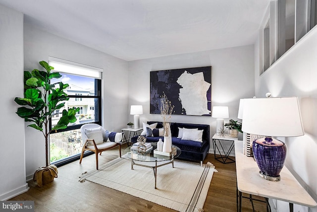 living area featuring dark wood finished floors and baseboards