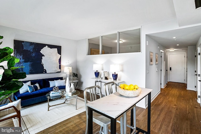 living room featuring baseboards and dark wood finished floors