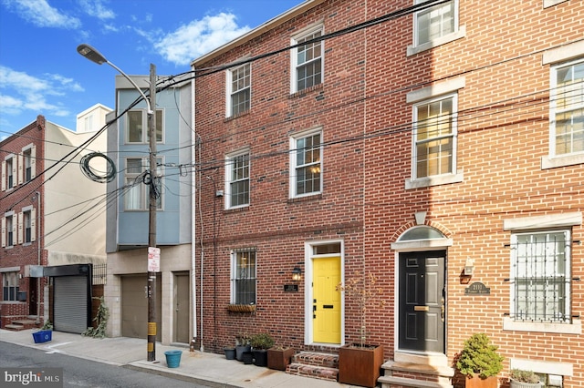 view of building exterior with entry steps and a garage