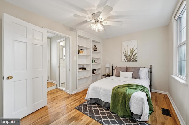 bedroom featuring light wood finished floors, multiple windows, and visible vents