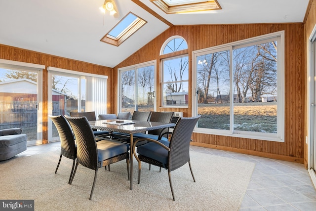 sunroom with vaulted ceiling with skylight