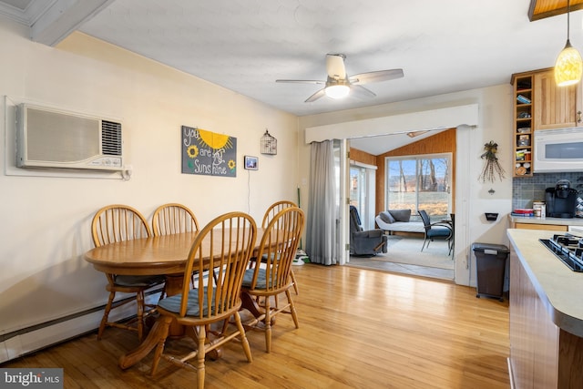 dining space with a wall unit AC, lofted ceiling, light wood-style floors, a baseboard heating unit, and a ceiling fan