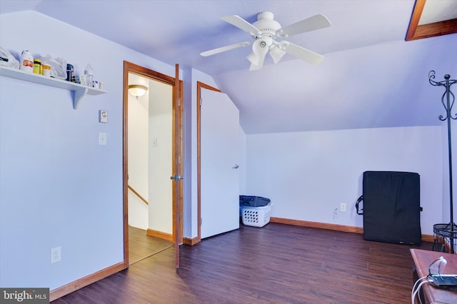 home office featuring lofted ceiling, baseboards, and wood finished floors