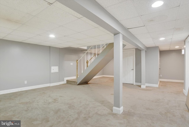 finished below grade area featuring baseboards, carpet, stairs, a paneled ceiling, and recessed lighting