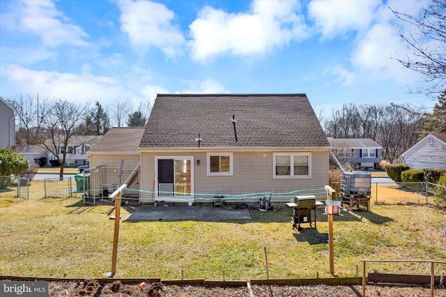 back of house with a patio area, a fenced backyard, a vegetable garden, and a lawn