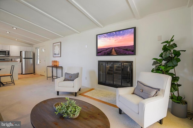 interior space featuring a glass covered fireplace, lofted ceiling with beams, and light carpet