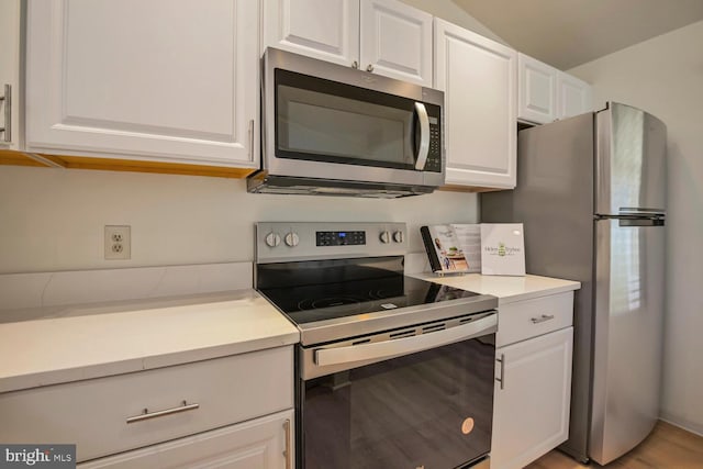 kitchen with appliances with stainless steel finishes, light countertops, and white cabinetry