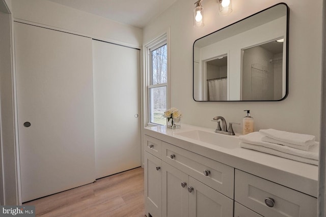 full bath with vanity and wood finished floors