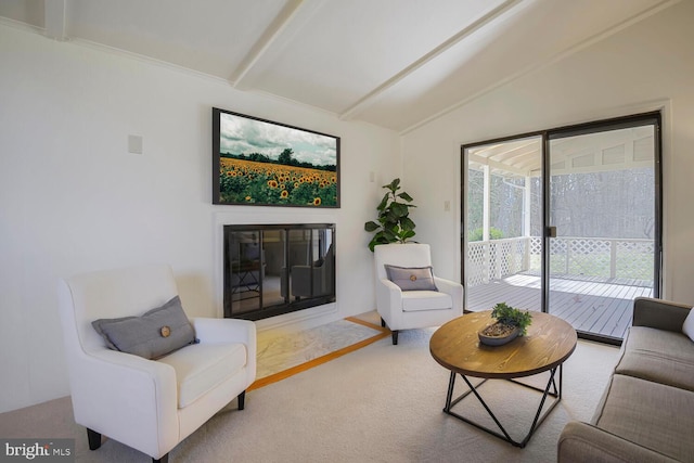 living room featuring a glass covered fireplace and lofted ceiling with beams