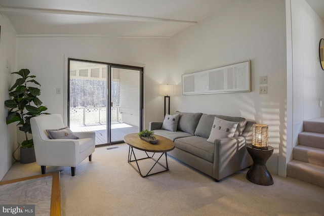 carpeted living area featuring visible vents and lofted ceiling