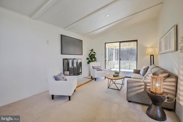 carpeted living area with vaulted ceiling with beams