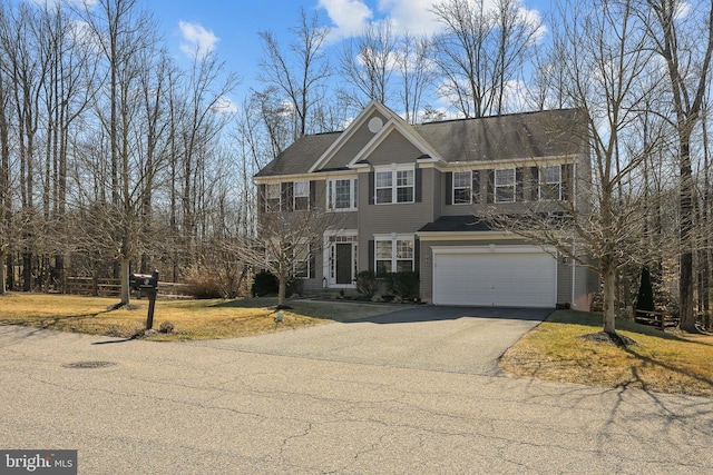 view of front of house featuring a front yard, driveway, and an attached garage