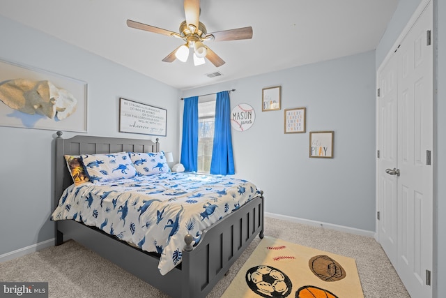 bedroom with baseboards, a closet, visible vents, and light colored carpet