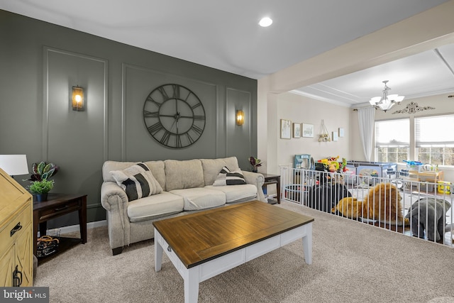 living area featuring crown molding, a notable chandelier, a decorative wall, light carpet, and beamed ceiling