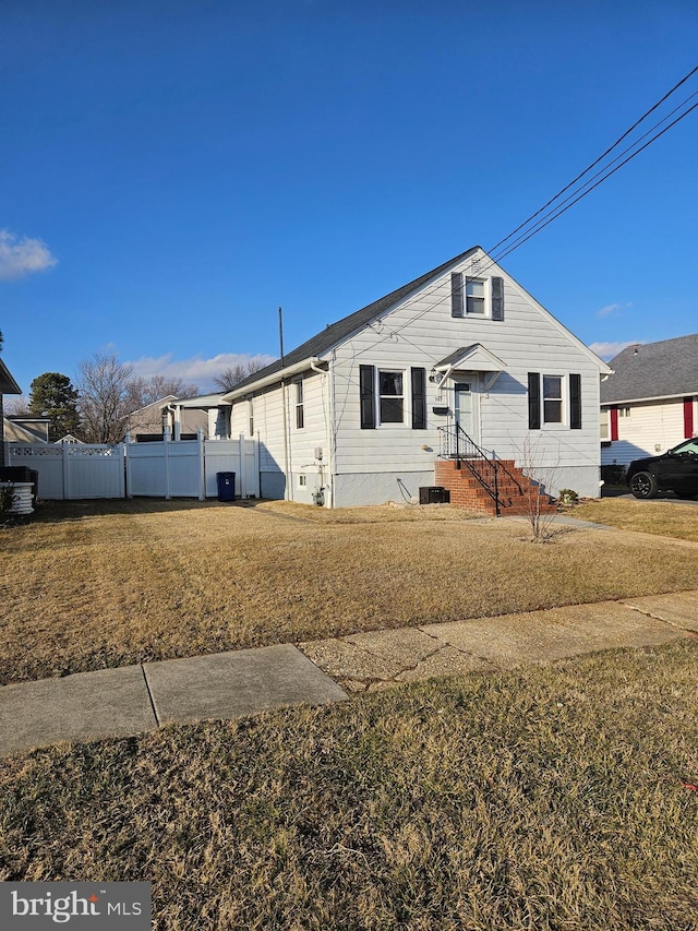 view of front of property with a front yard and fence